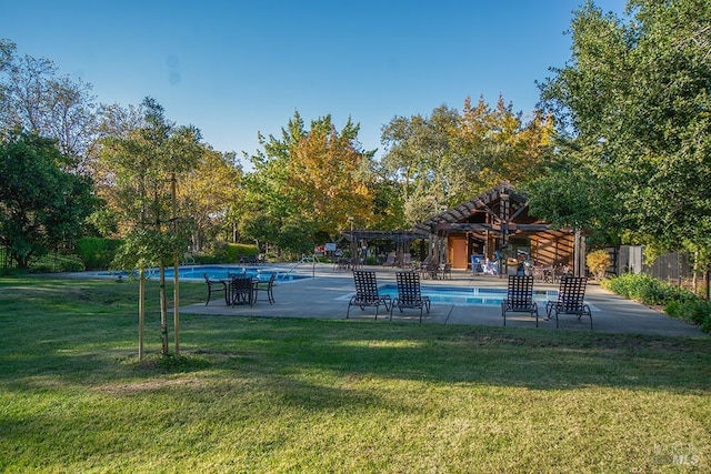 view of swimming pool with a pergola and a yard