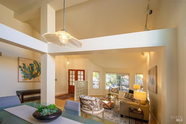 living room with french doors and high vaulted ceiling