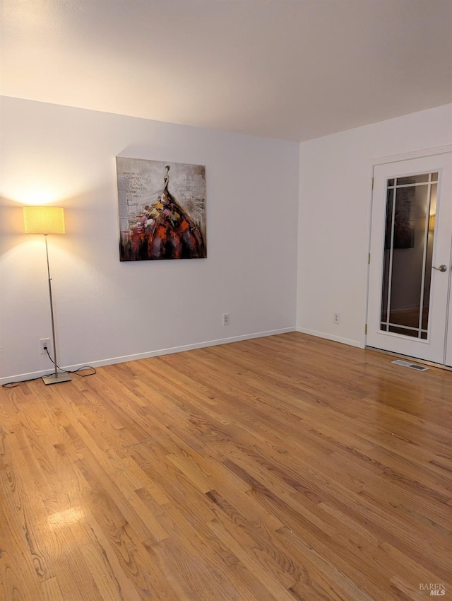 spare room with light hardwood / wood-style floors