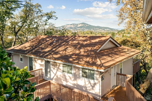 back of house with a deck with mountain view