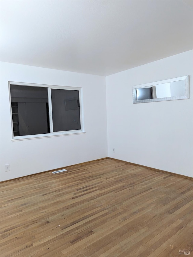 spare room featuring hardwood / wood-style floors