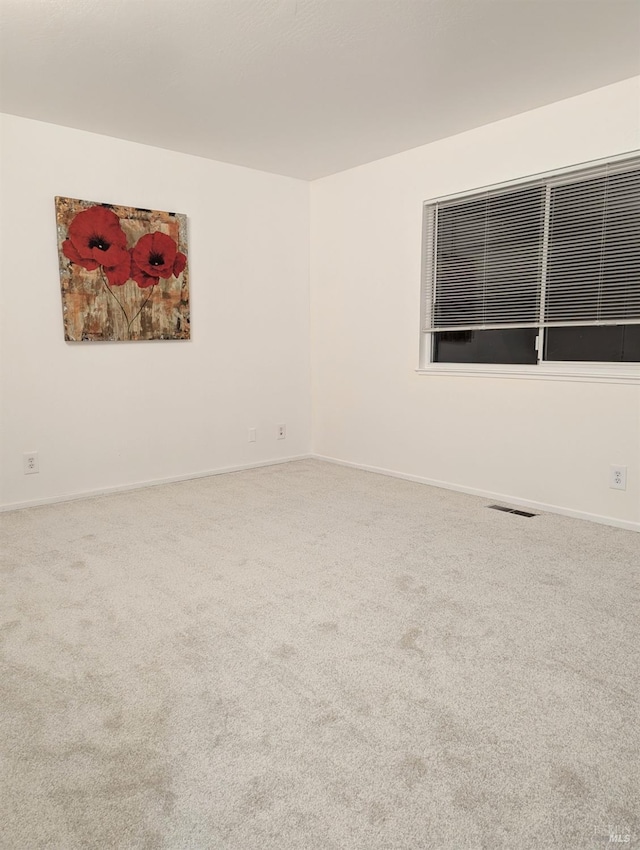 unfurnished room featuring carpet