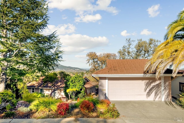 view of front of house featuring a garage and a mountain view