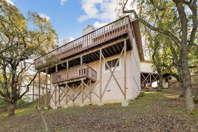 rear view of house featuring a deck