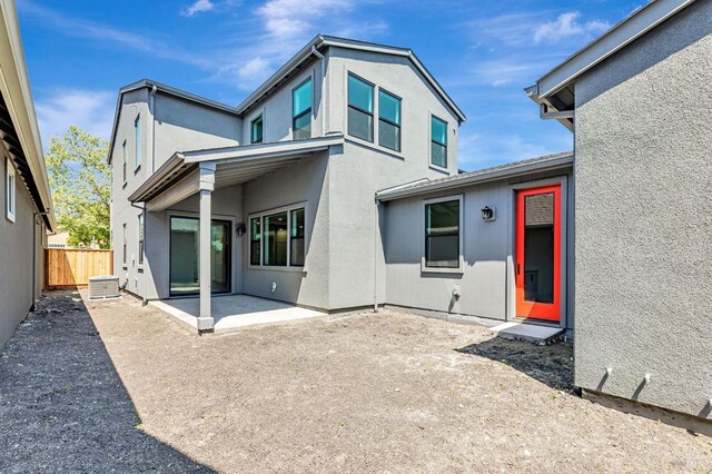 back of house featuring fence, a patio area, and stucco siding