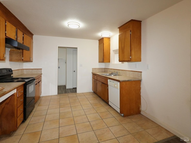 kitchen with dishwasher, light tile patterned floors, sink, and black / electric stove