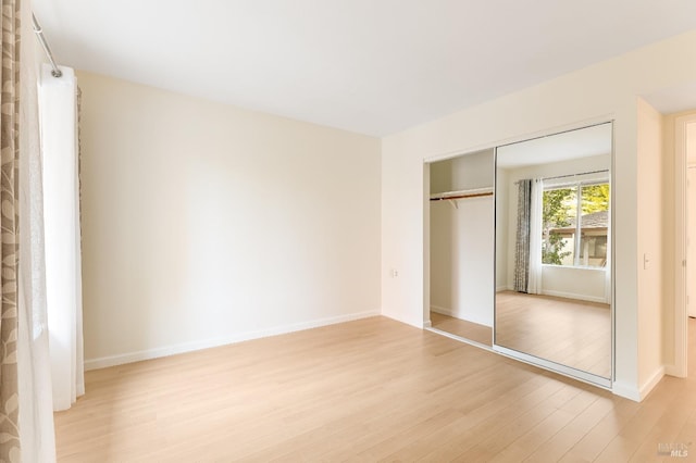 3473 Tice Creek Dr Unit 1, Walnut Creek, CA 94595 - unfurnished bedroom with light wood-style flooring, a closet, and baseboards