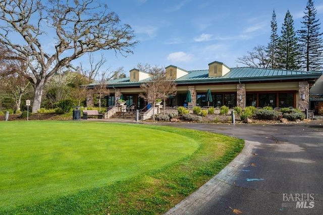3473 Tice Creek Dr Unit 1, Walnut Creek, CA 94595 - back of property with a lawn, metal roof, and a porch