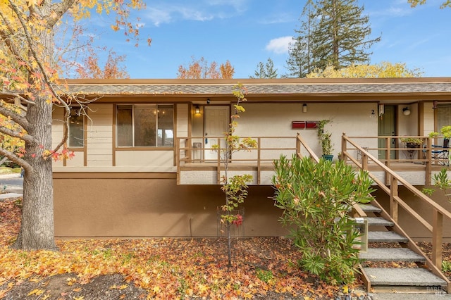 3473 Tice Creek Dr Unit 1, Walnut Creek, CA 94595 - rear view of house with stairs, stucco siding, a shingled roof, and a porch