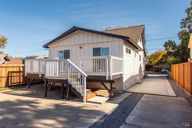 view of front of house featuring a deck and a patio