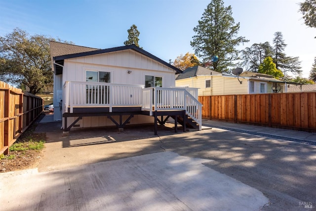 back of house featuring a deck