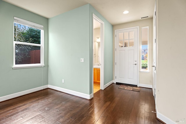 foyer featuring dark wood-type flooring, recessed lighting, visible vents, and baseboards