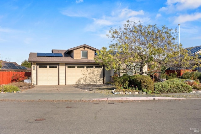 view of front facade with a garage and solar panels