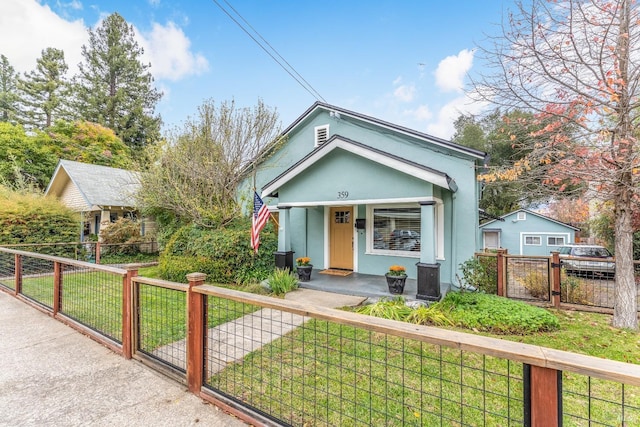 bungalow-style house with a front lawn and covered porch