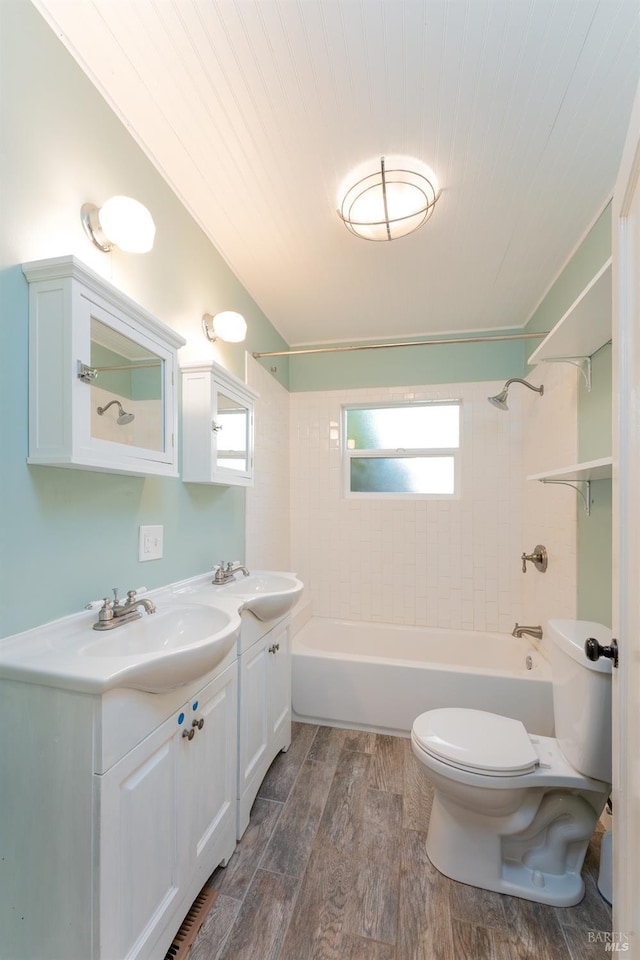 full bathroom with vanity, toilet, and tiled shower / bath