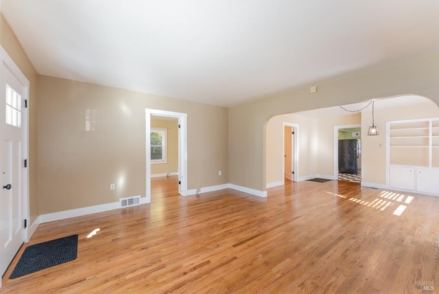 unfurnished living room featuring light hardwood / wood-style floors