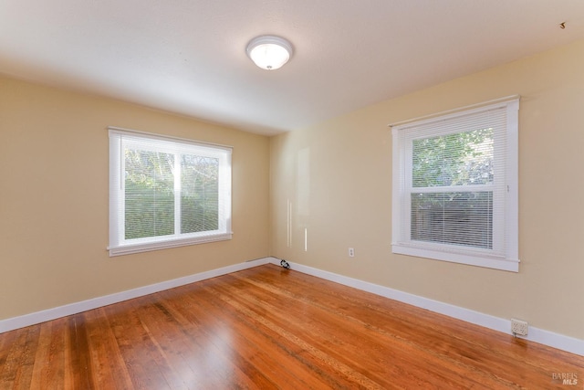 empty room with hardwood / wood-style flooring