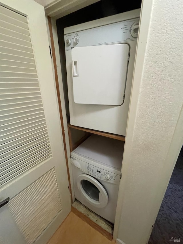 laundry room featuring stacked washer / dryer