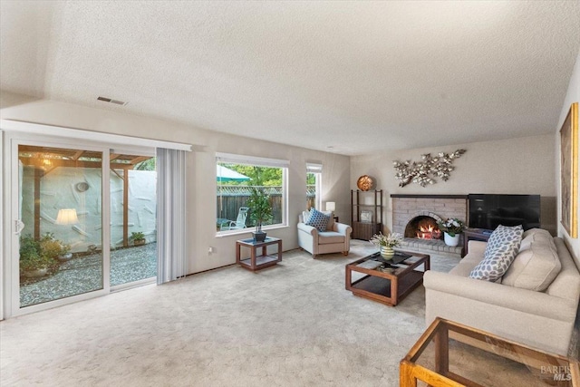 carpeted living room featuring a fireplace and a textured ceiling