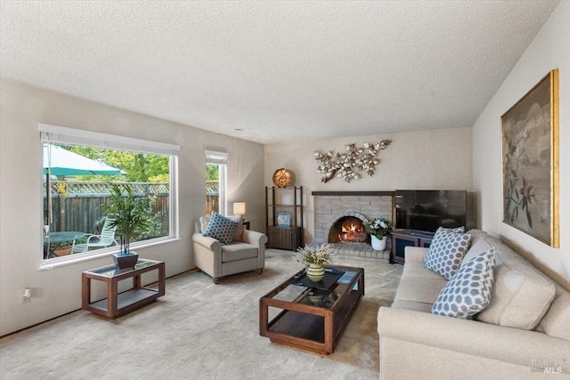 living room with a fireplace, carpet floors, and a textured ceiling