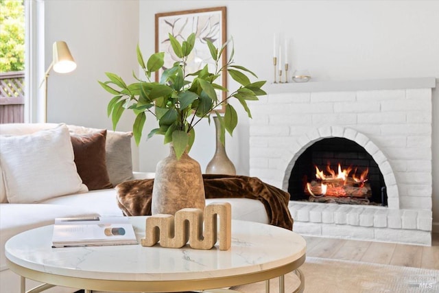 interior details with a brick fireplace and wood finished floors