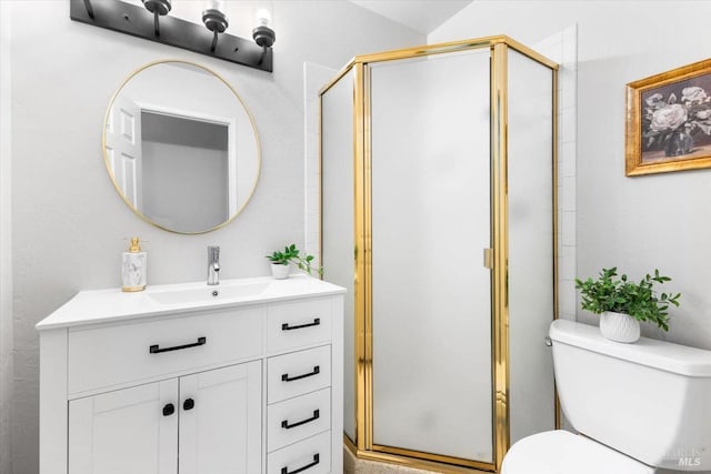 bathroom with toilet, a stall shower, and vanity