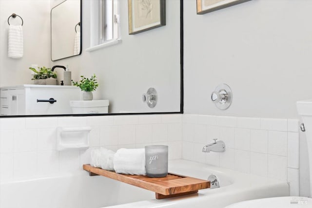 bathroom with a tub and toilet