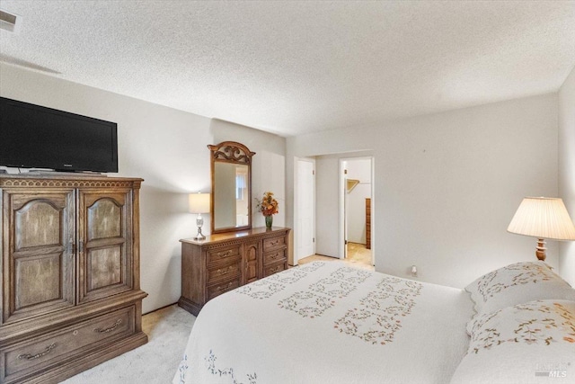 carpeted bedroom with a textured ceiling