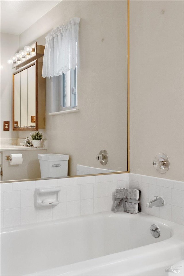 bathroom featuring a bathing tub and toilet