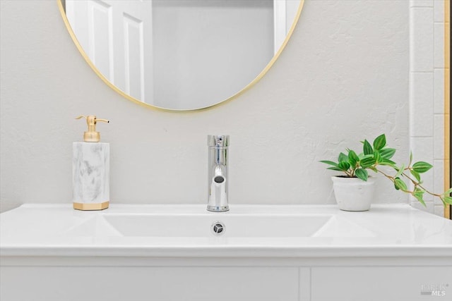 bathroom with a sink and a textured wall