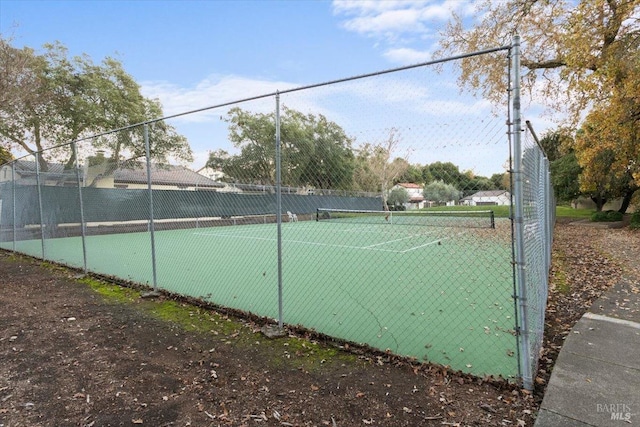 view of sport court with fence