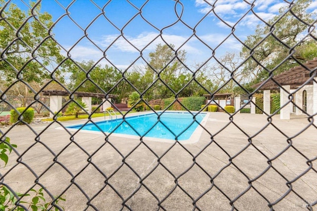 view of swimming pool featuring a patio, a fenced in pool, and a pergola