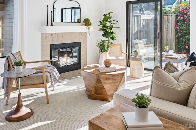 interior space with a tile fireplace and carpet floors