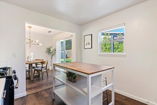 dining room featuring a chandelier and dark wood-type flooring