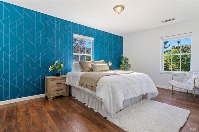 bedroom with dark hardwood / wood-style floors