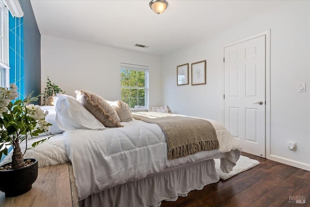 bedroom featuring dark hardwood / wood-style flooring