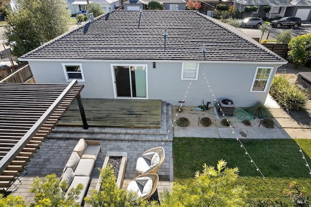 rear view of property with a lawn, cooling unit, and a patio