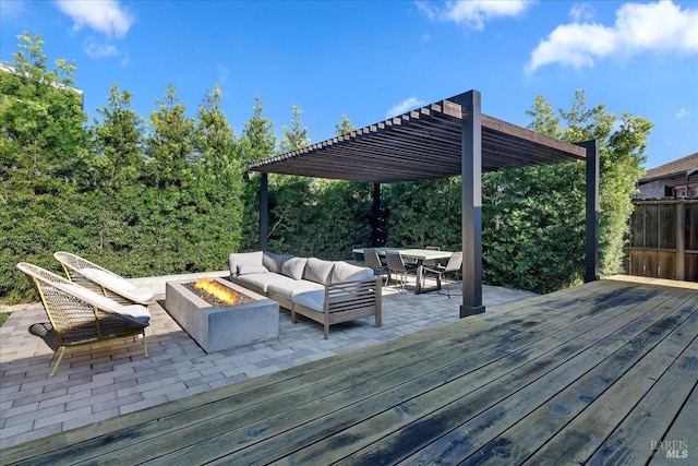 wooden terrace featuring an outdoor living space with a fire pit