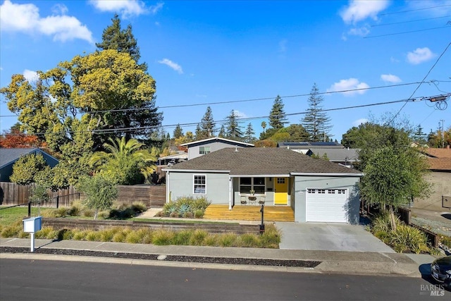 single story home with a garage and covered porch