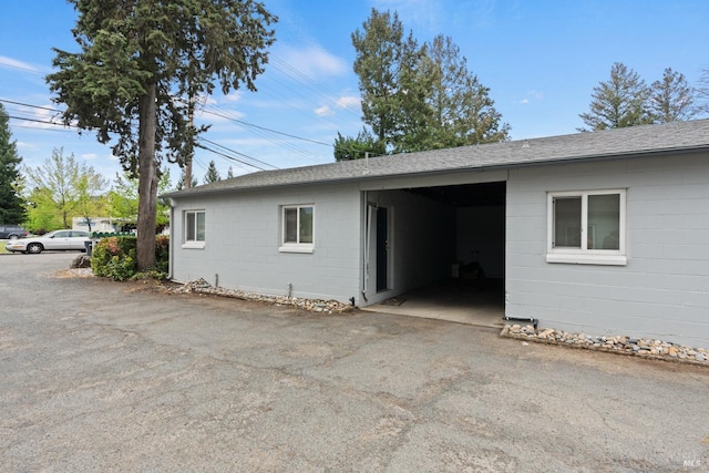 view of side of home with a carport