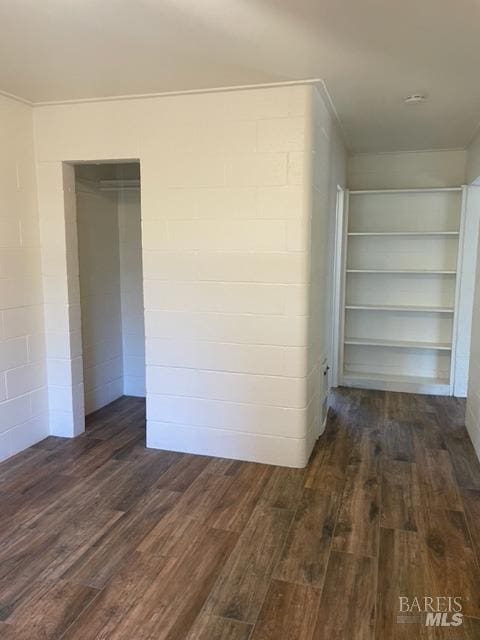 interior space with dark hardwood / wood-style floors and built in features