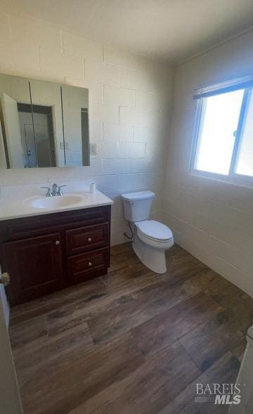 bathroom featuring hardwood / wood-style floors, vanity, and toilet