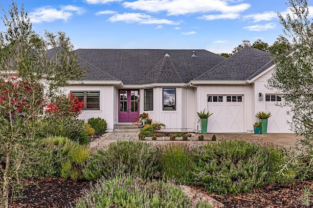 view of front of house with a garage and french doors