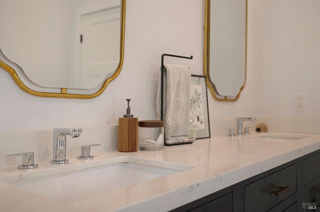 bathroom featuring a sink and double vanity