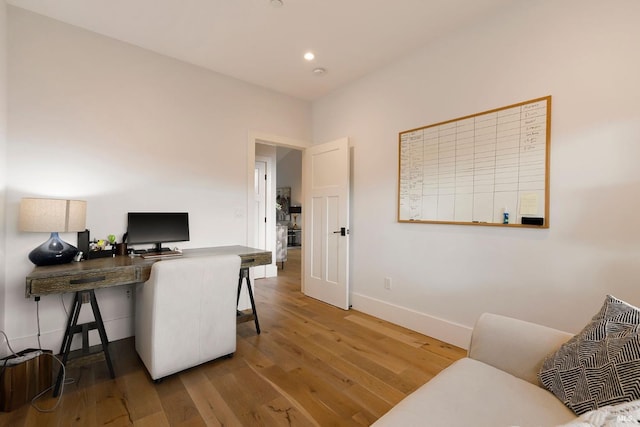 office space featuring recessed lighting, wood finished floors, and baseboards