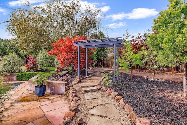 view of yard featuring fence, a pergola, and a patio