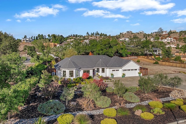 ranch-style home featuring concrete driveway and a garage