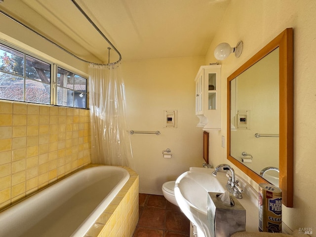 full bathroom with shower / tub combo, sink, tile patterned floors, and toilet