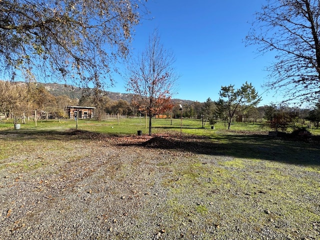 view of yard featuring a rural view and a mountain view