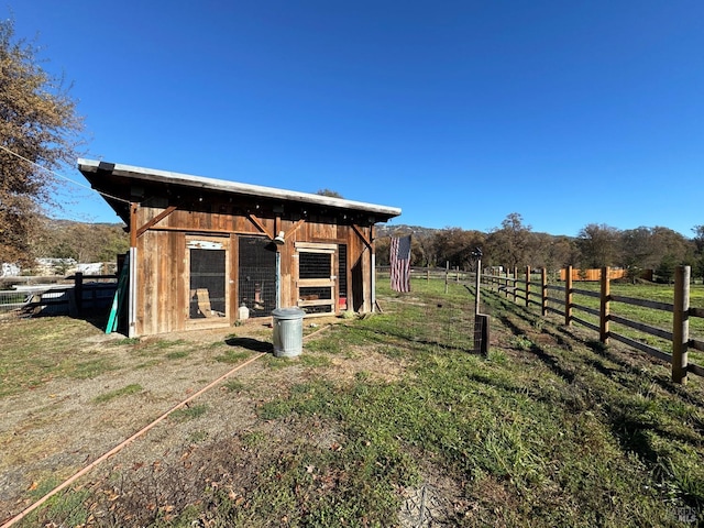 exterior space with an outbuilding and a rural view